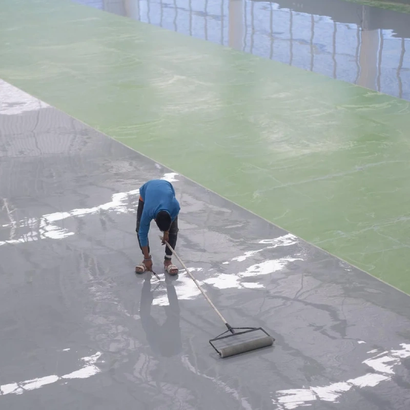 A man putting the Anti-Static Epoxy Floor Coating for Industrial Units