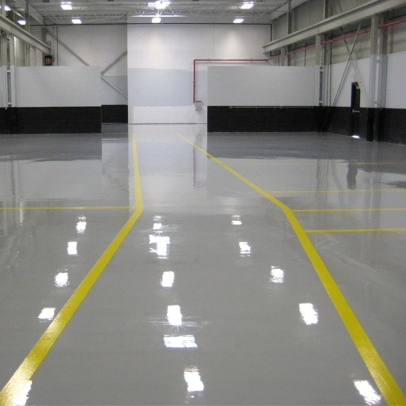 The floor has bright yellow lines painted on it, indicating a sports court. The specific type of flooring used is Sports Facility self-leveling epoxy flooring