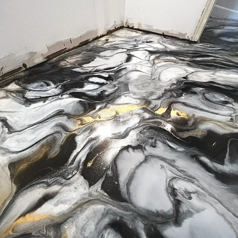 A close-up view of an epoxy floor featuring a dramatic Abstract Art epoxy flooring design.