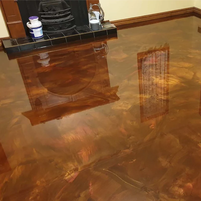 Pearlescent epoxy flooring, featuring a metallic or marble-like finish in warm tones of bronze, gold, and copper.