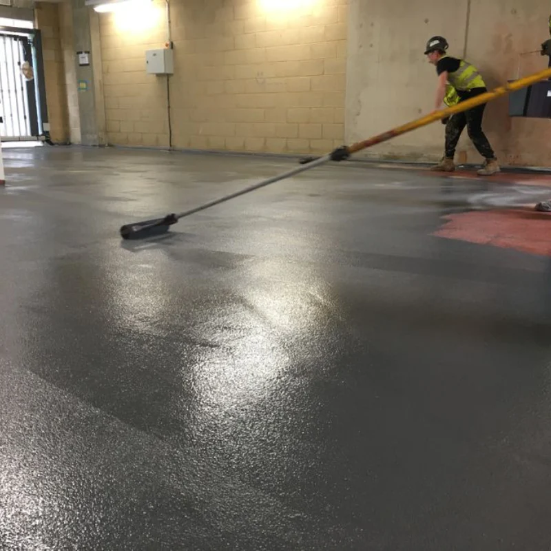 The newly applied Impact-Resistant epoxy flooring has a wet, shiny finish.